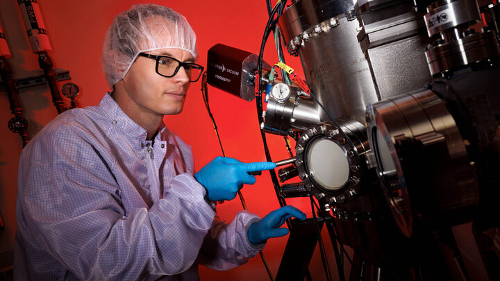 Robert Streubel, assistant professor of physics and astronomy, transfers samples in an ultrahigh vacuum before co-evaporating amorphous magnetic films at cryogenic temperatures inside his lab in Jorgensen Hall.