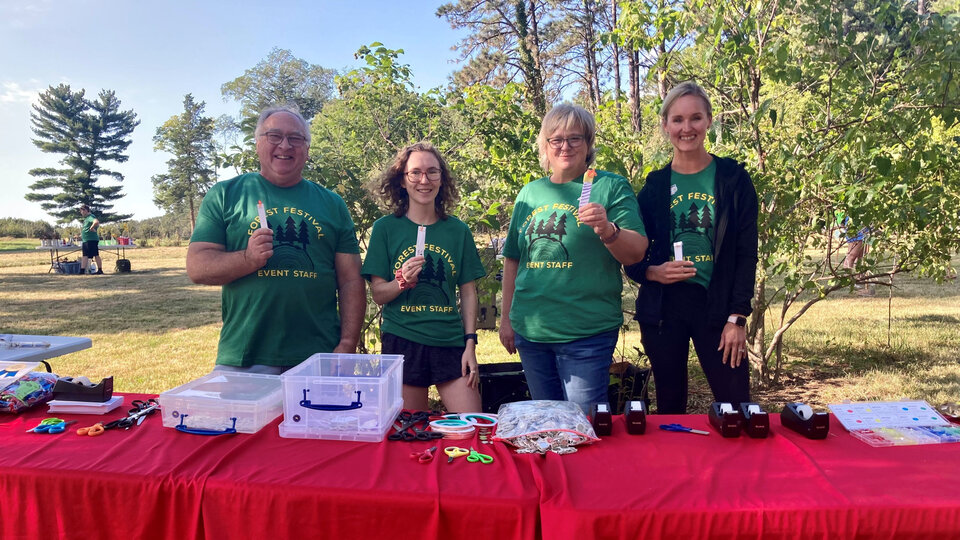 EQUATE outreach team posing with their quantum education supplies at Forest Fest.