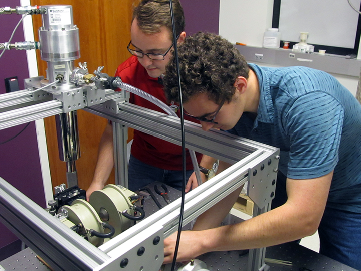 Community college student learning to use a piece of equipment