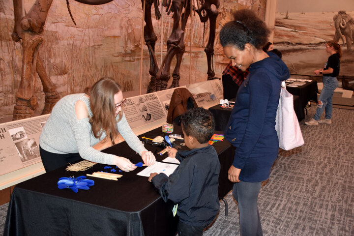 A young boy engaged at a STEM booth.
