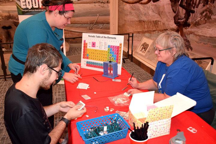 Two people are engaged in a circuits experiment ran by Jodi Sangster.