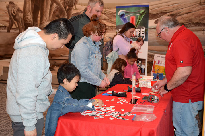Families engaging with a circuit themed booth.